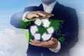 Businessman in recyling sustainable business concept. Businessman recycle symbol stacked on green grass with world map shape and