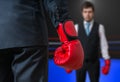 Businessman with red boxing gloves is boxing in ring with his boss Royalty Free Stock Photo