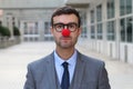 Businessman with a red clown nose Royalty Free Stock Photo