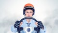 Businessman in a red helmet with steering wheel Royalty Free Stock Photo