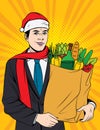 Businessman in red Santa Claus hat doing grocery shopping Royalty Free Stock Photo