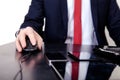 Businessman in red tie working on the computer. On the table is