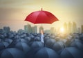 Businessman with red umbrella among others, unique different concept Royalty Free Stock Photo