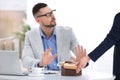 Businessman refusing to take bribe at table Royalty Free Stock Photo