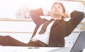 Businessman relaxes sitting behind a Desk