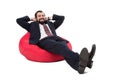 Businessman relaxing on bean bag chair Royalty Free Stock Photo