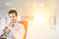 Businessman relaxing in chair in empty office