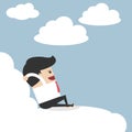 Businessman relaxing on a cloud