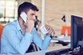 Businessman relaxing with legs up on desk, drinking coffee while dreaming about future at workplace in modern office. Royalty Free Stock Photo