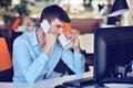 Businessman relaxing with legs up on desk, drinking coffee while dreaming about future at workplace in modern office. Royalty Free Stock Photo