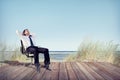 Businessman Relaxing on Office Chair at Beach Royalty Free Stock Photo