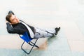 A businessman relaxing on the street