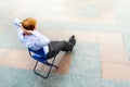 A businessman relaxing on the street