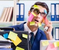 Businessman with reminder notes in multitasking concept