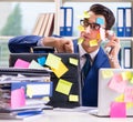 Businessman with reminder notes in multitasking concept