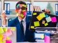 Businessman with reminder notes in multitasking concept