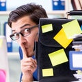 Businessman with reminder notes in multitasking concept