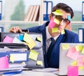 Businessman with reminder notes in multitasking concept