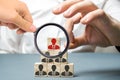 Businessman removes wooden block with worker image. The boss dismisses the employee from the team. Personnel Management. Bad Royalty Free Stock Photo