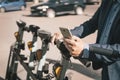 Young business man in a suit riding an electric scooter on business meeting. Ecological transportation concept. rent an Royalty Free Stock Photo