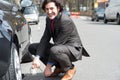 Businessman repairing car roadside Royalty Free Stock Photo