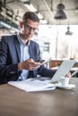 A businessman in a restaurant having coffee and taking care of his business Royalty Free Stock Photo