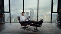 Businessman resting in chair with newspaper. Manager reading newspaper in office Royalty Free Stock Photo