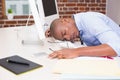 Businessman resting head on computer keyboard Royalty Free Stock Photo