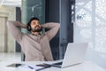 Businessman resting inside office with his hands behind his head with eyes closed dozing, man well done successfully Royalty Free Stock Photo