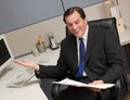 Businessman reviewing file folder at desk