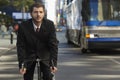 Businessman Riding Bicycle On City Street