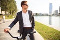 Businessman riding bicycle to work on urban street in morning. Royalty Free Stock Photo