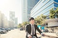 Businessman riding bicycle to work on urban street at morning Royalty Free Stock Photo