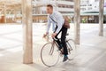 Businessman riding bicycle to work on urban street in morning .transport and healthy Royalty Free Stock Photo