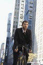 Businessman Riding Bicycle On Urban Street Royalty Free Stock Photo