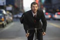 Businessman Riding Bicycle On Urban Street