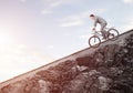 Businessman riding downhill by bike