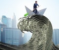 Businessman riding paper boat in dollar sea Royalty Free Stock Photo