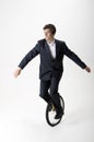 Businessman riding unicycle Royalty Free Stock Photo