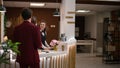 Businessman rings service bell in lobby