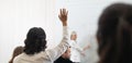 Businessman rises hand up for the question in the diverse employees business people team group. The colleagues discussing and Royalty Free Stock Photo