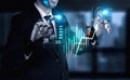 Businessman with robotic hands analyzing financial growth charts in a digital environment showcasing artificial Royalty Free Stock Photo