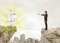 Businessman on rock mountain with a dollar mark