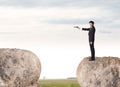 Businessman on rock mountain