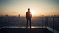 Businessman on Rooftop at Sunrise Sunset with Cityscape Silhouette