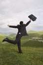 Businessman Running With Briefcase In Field Royalty Free Stock Photo