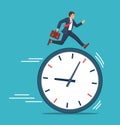 Businessman running on clock representing deadline Royalty Free Stock Photo