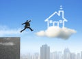 Businessman running and jumping on cloud dream house