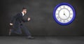 Businessman running while looking at clock