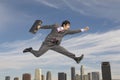 Businessman Running Midair Above City Royalty Free Stock Photo
